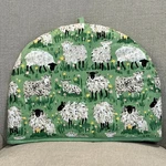 Ulster Weavers Cotton Tea Cosy Woolly Sheep Green Background **read**. Fixed Price $20.00.