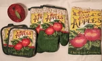 7 Pc Kitchen Set - 2 Pot Holders, Oven Mitts, Towels & 1 Wicker Apple Basket. Fixed Price $9.95.